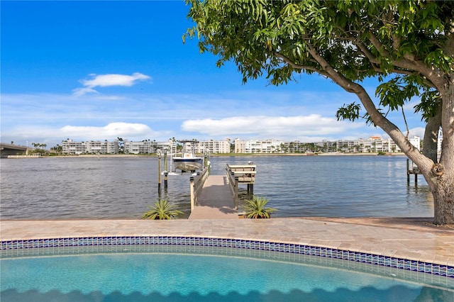 view of swimming pool featuring a dock and a water view