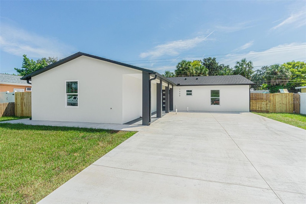 rear view of house with a yard