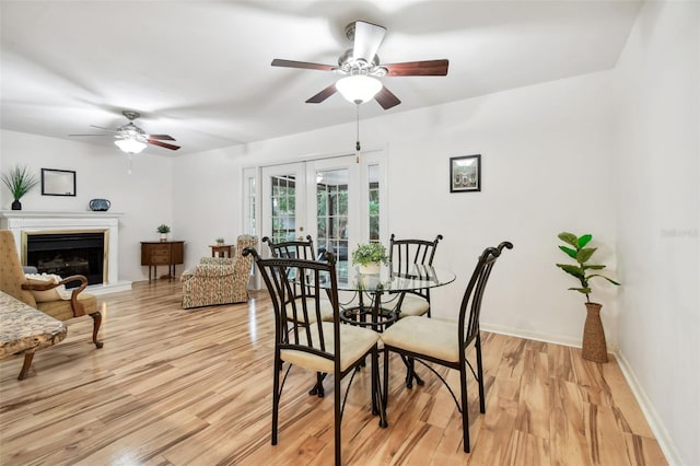 dining area with ceiling fan, french doors, and light hardwood / wood-style floors