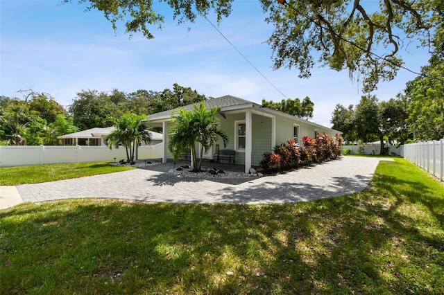 view of property exterior featuring a garage, a porch, and a yard