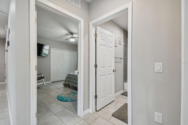 hall with light tile patterned floors