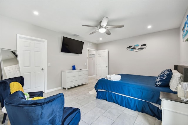 bedroom with ceiling fan and light tile patterned floors