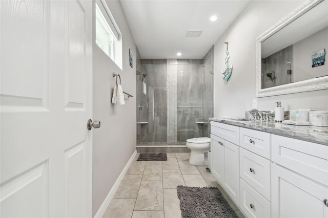 bathroom with vanity, toilet, and a shower with shower door