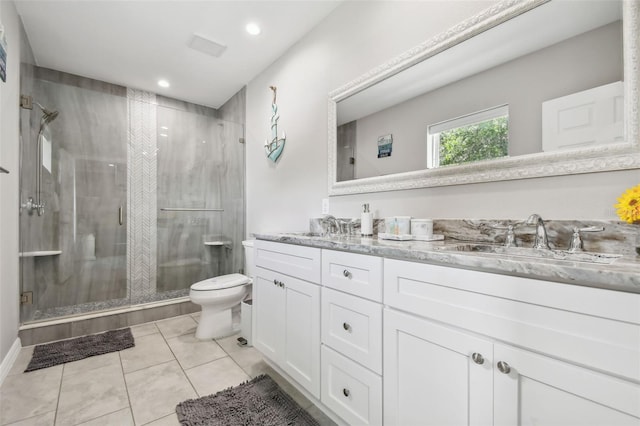 bathroom with toilet, tile patterned flooring, vanity, and a shower with shower door