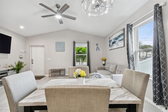 tiled dining room with ceiling fan and lofted ceiling