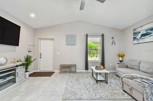 living room featuring ceiling fan, lofted ceiling, and light tile patterned floors