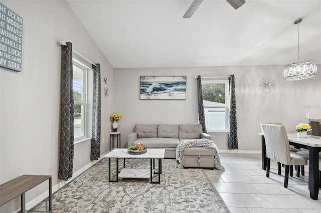 living room featuring vaulted ceiling, light tile patterned floors, and ceiling fan