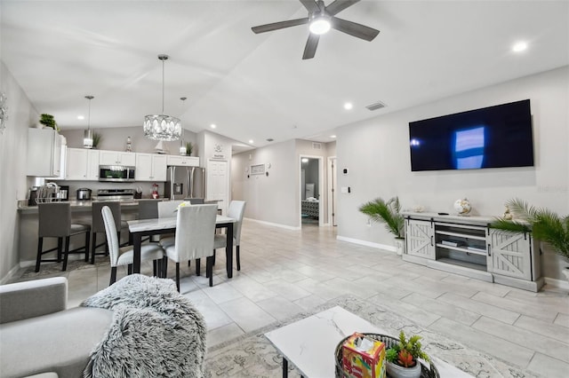 living room with ceiling fan, lofted ceiling, and light tile patterned floors