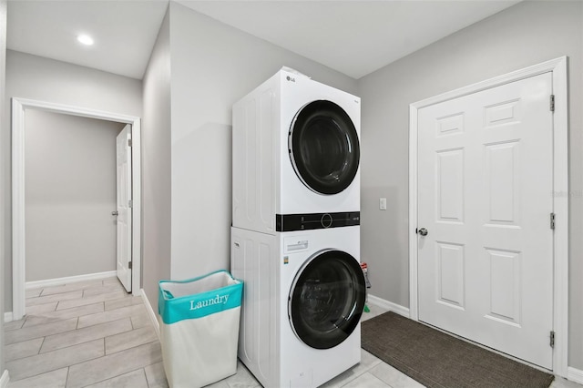 laundry room with stacked washer / drying machine