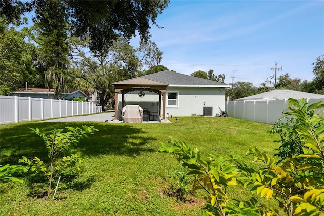 view of yard with a gazebo, a patio area, and central air condition unit