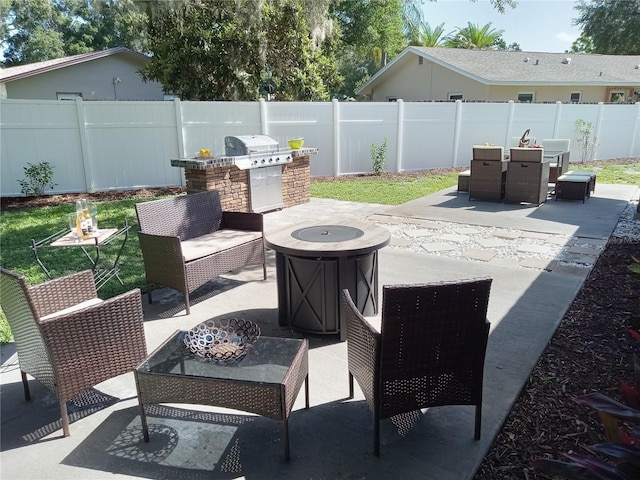 view of patio with area for grilling and an outdoor fire pit