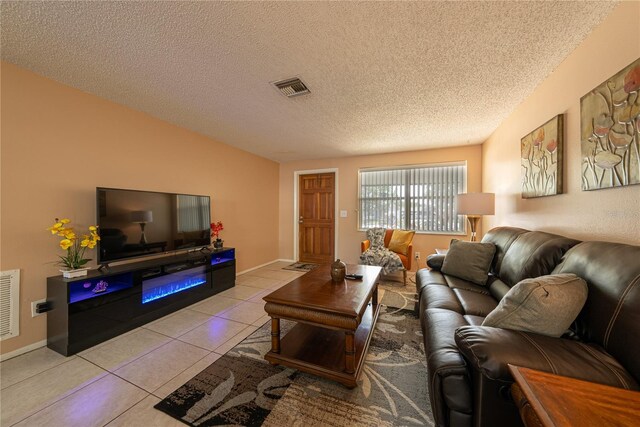 living room with light tile patterned floors and a textured ceiling