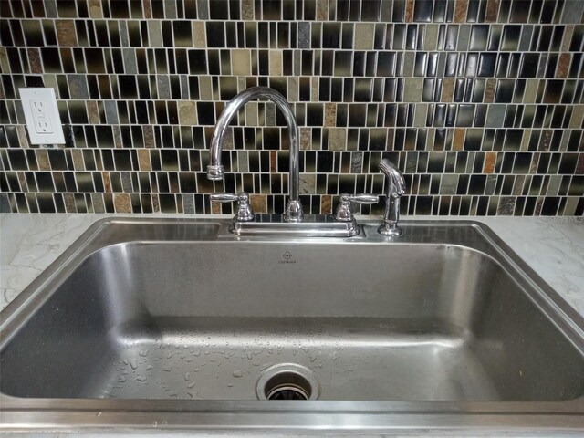 room details with light stone countertops and sink