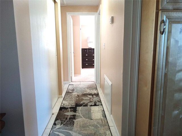 hall featuring light tile patterned flooring