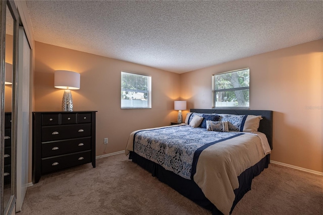 bedroom featuring a textured ceiling and carpet floors