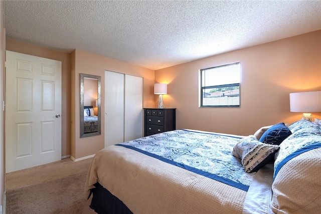 bedroom featuring carpet, a textured ceiling, and a closet