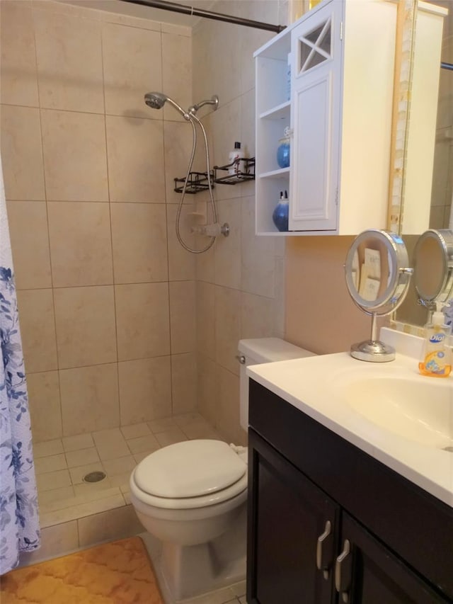 bathroom with a shower with shower curtain, vanity, toilet, and tile patterned floors