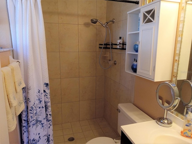 bathroom featuring tile patterned floors, vanity, curtained shower, and toilet