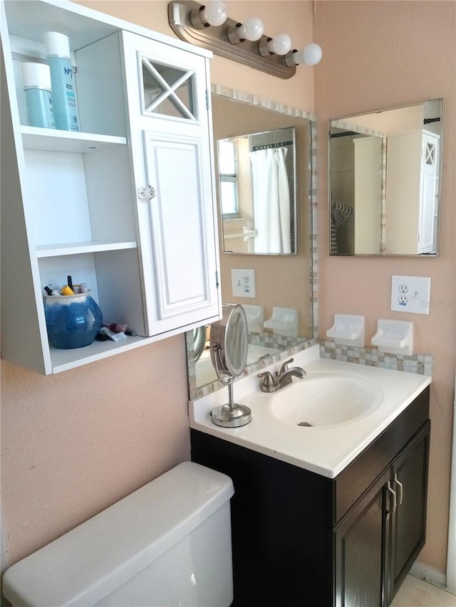 bathroom featuring vanity and toilet