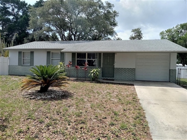 ranch-style home featuring a garage and a front lawn