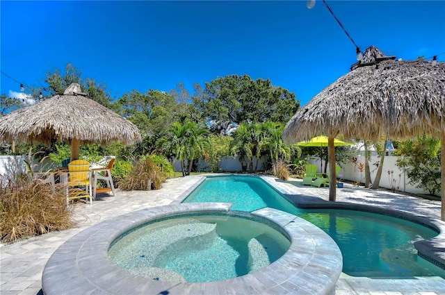 view of swimming pool with an in ground hot tub and a patio