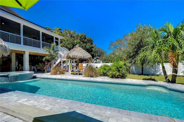 view of swimming pool featuring a patio area and an in ground hot tub