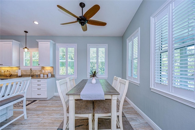 dining space featuring ceiling fan and light wood-type flooring