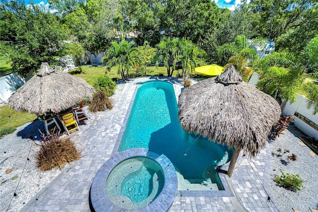 view of swimming pool with an in ground hot tub