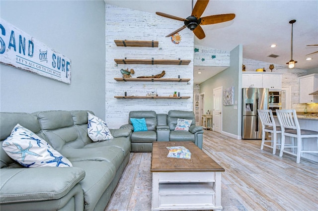 living room featuring light wood-type flooring, high vaulted ceiling, and ceiling fan