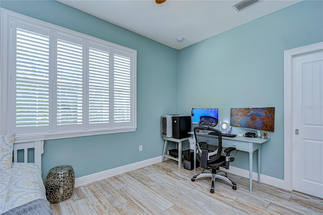 office area with plenty of natural light and light hardwood / wood-style floors