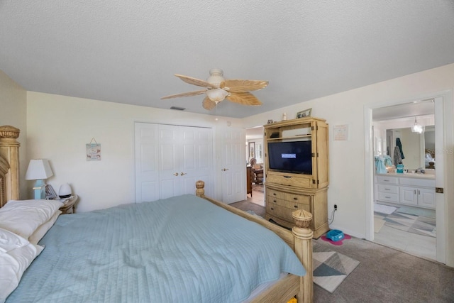 bedroom with a textured ceiling, carpet flooring, a closet, and ceiling fan