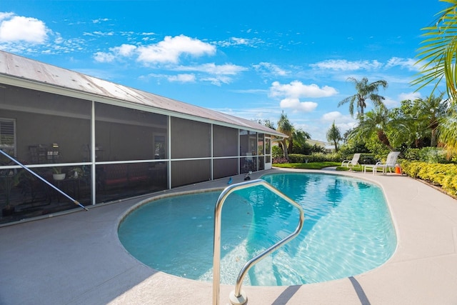 view of pool featuring a patio area and a sunroom