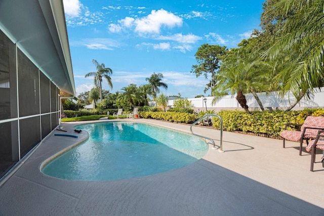 view of pool featuring a patio and a sunroom