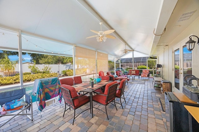 sunroom with vaulted ceiling and ceiling fan