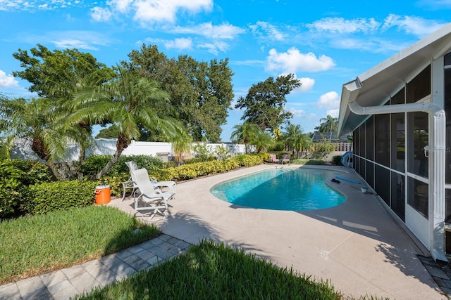 view of pool with a patio and a sunroom