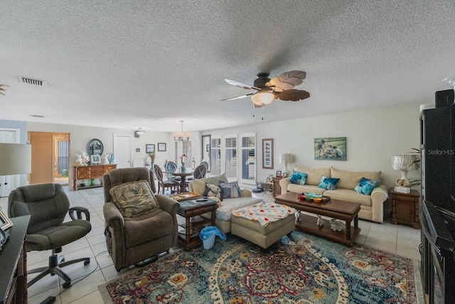 tiled living room with ceiling fan and a textured ceiling