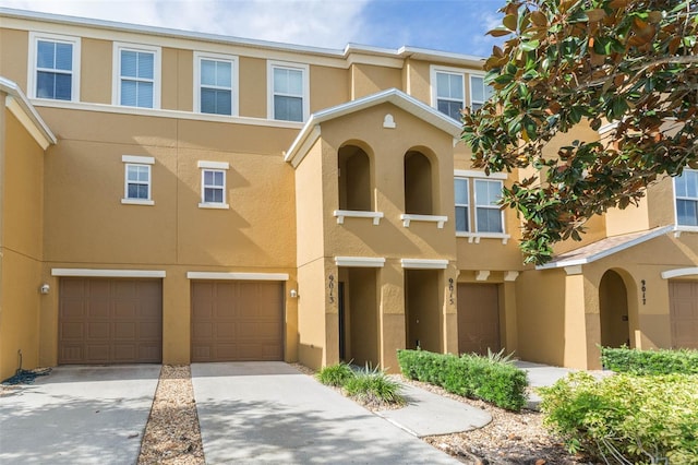 townhome / multi-family property featuring a garage