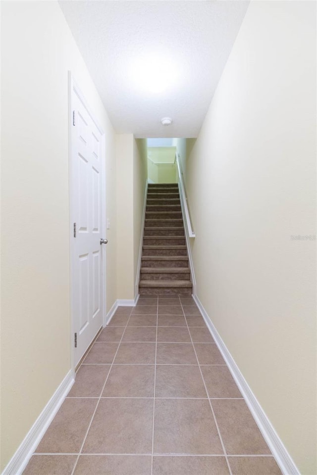 staircase featuring tile patterned floors