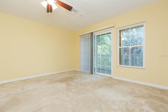 carpeted spare room with ceiling fan