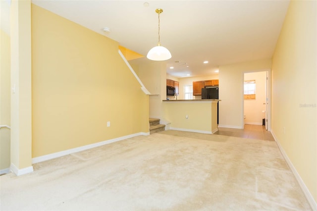 unfurnished living room with light colored carpet