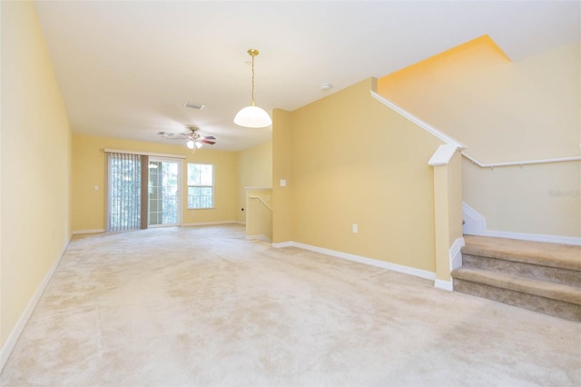 interior space featuring ceiling fan and carpet