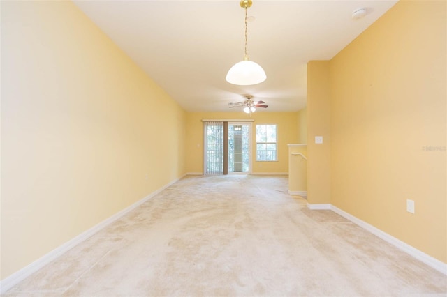 carpeted spare room with lofted ceiling and ceiling fan