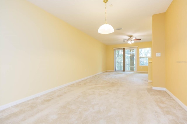 carpeted spare room with ceiling fan