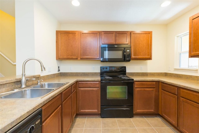 kitchen with black appliances, light tile patterned floors, and sink