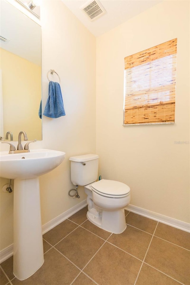 bathroom with sink, tile patterned flooring, and toilet