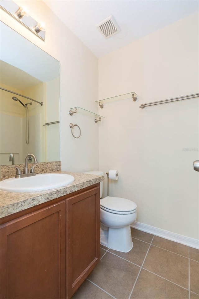 bathroom with walk in shower, tile patterned flooring, vanity, and toilet