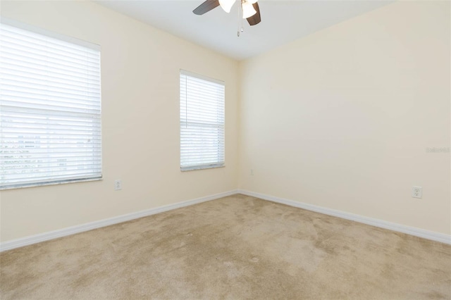 carpeted empty room featuring ceiling fan