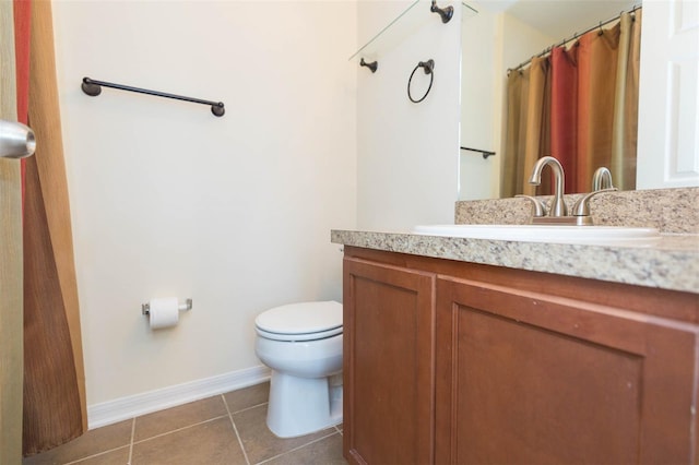 bathroom featuring vanity, tile patterned flooring, and toilet