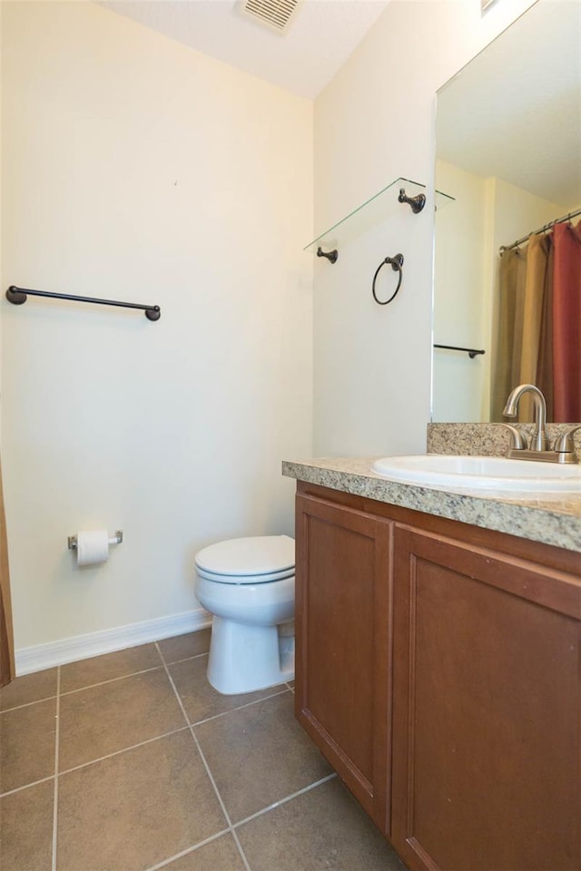 bathroom featuring tile patterned floors, vanity, and toilet