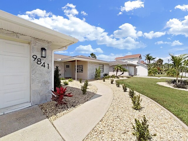 exterior space with a garage and a yard